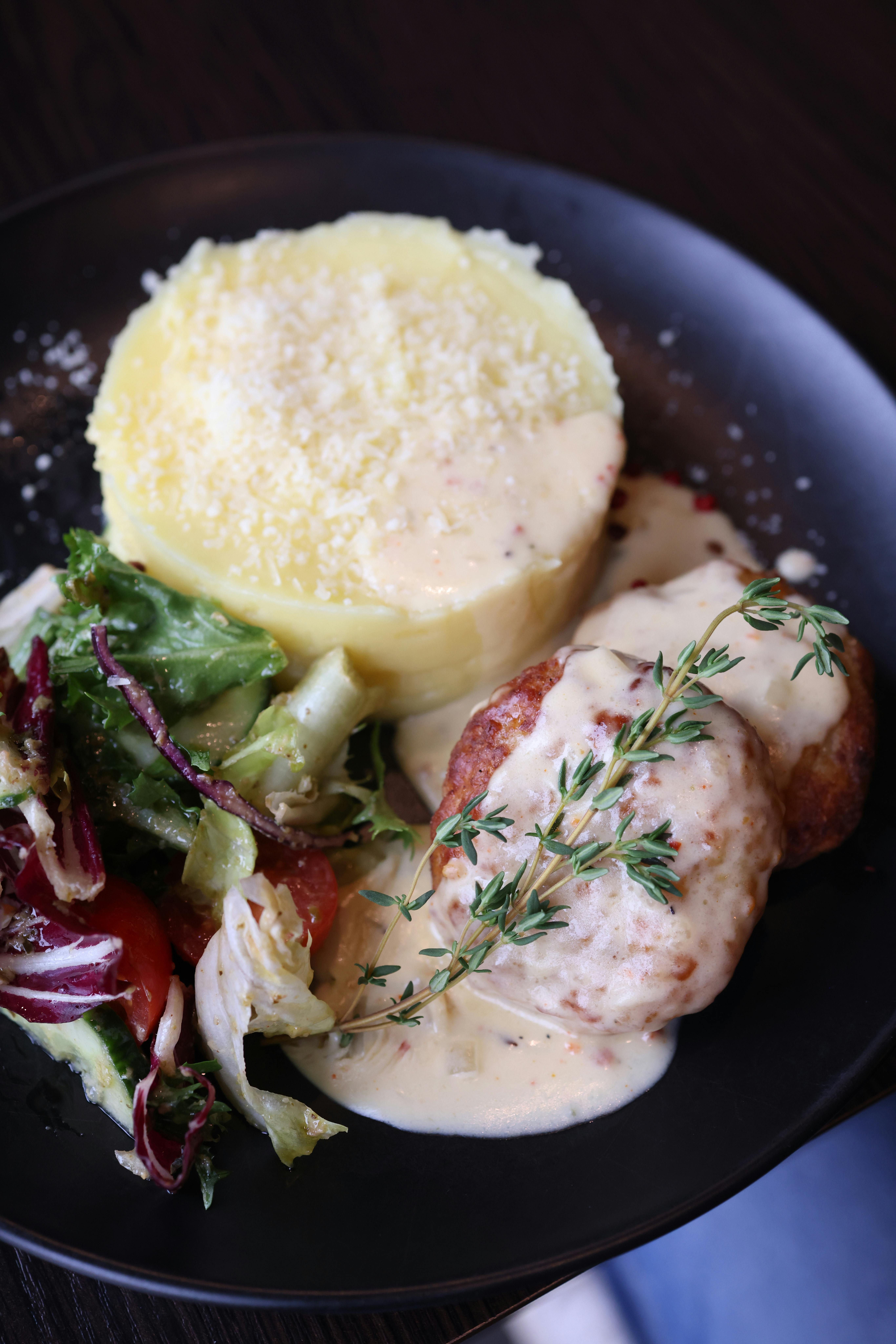 Tuscan cooking ingredients with fresh herbs, tomatoes, and garlic
