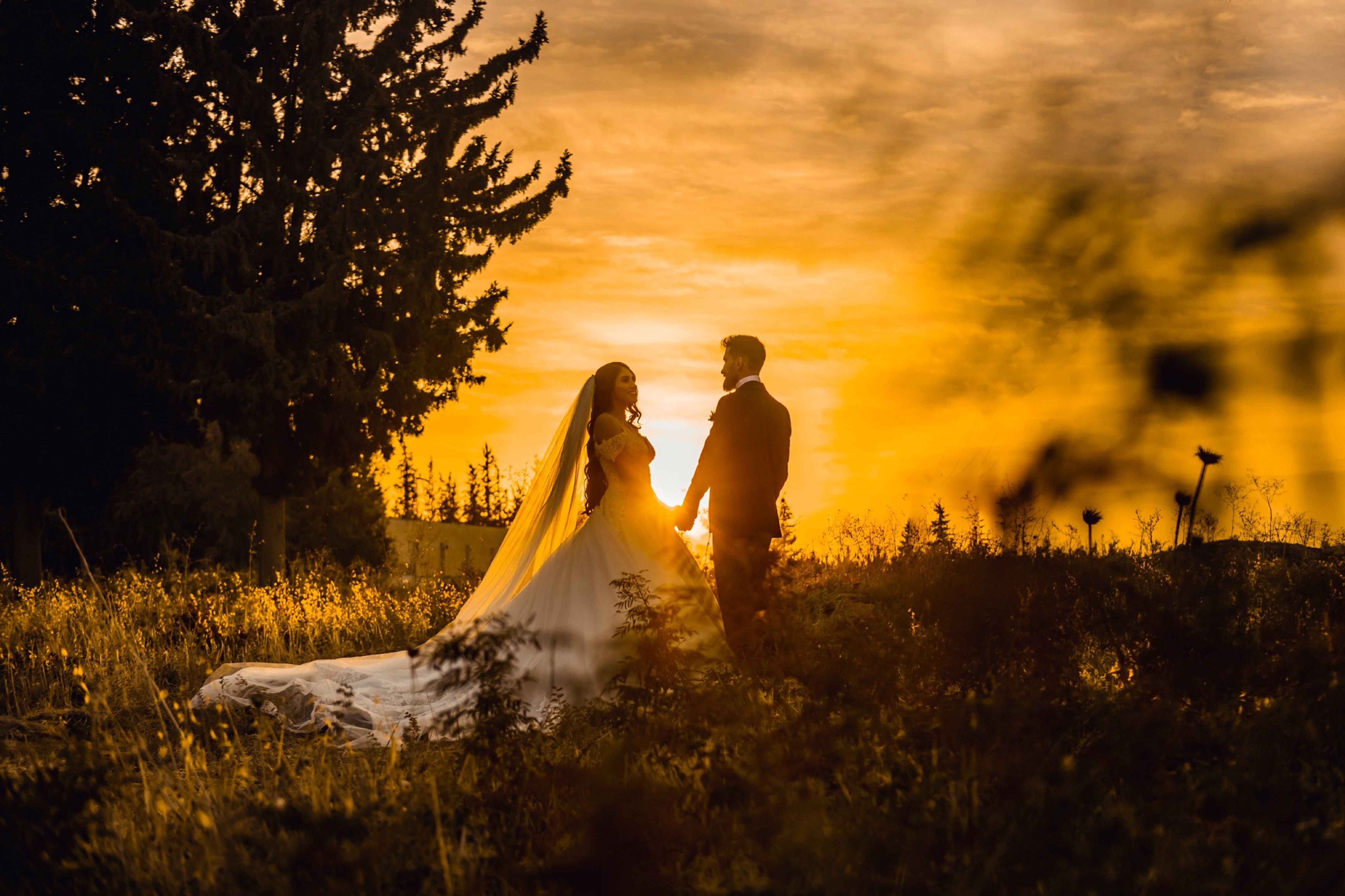 Couple sharing a romantic moment outdoors during golden hour