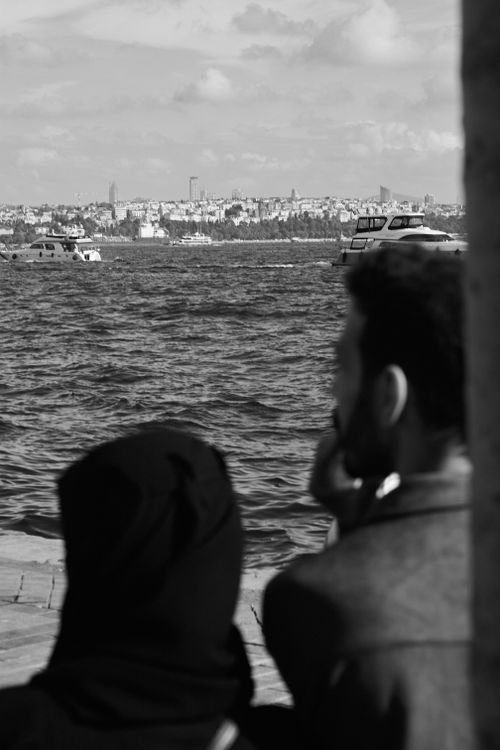 Free Monochrome shot of a couple by the Bosphorus overlooking Istanbul's skyline. Stock Photo