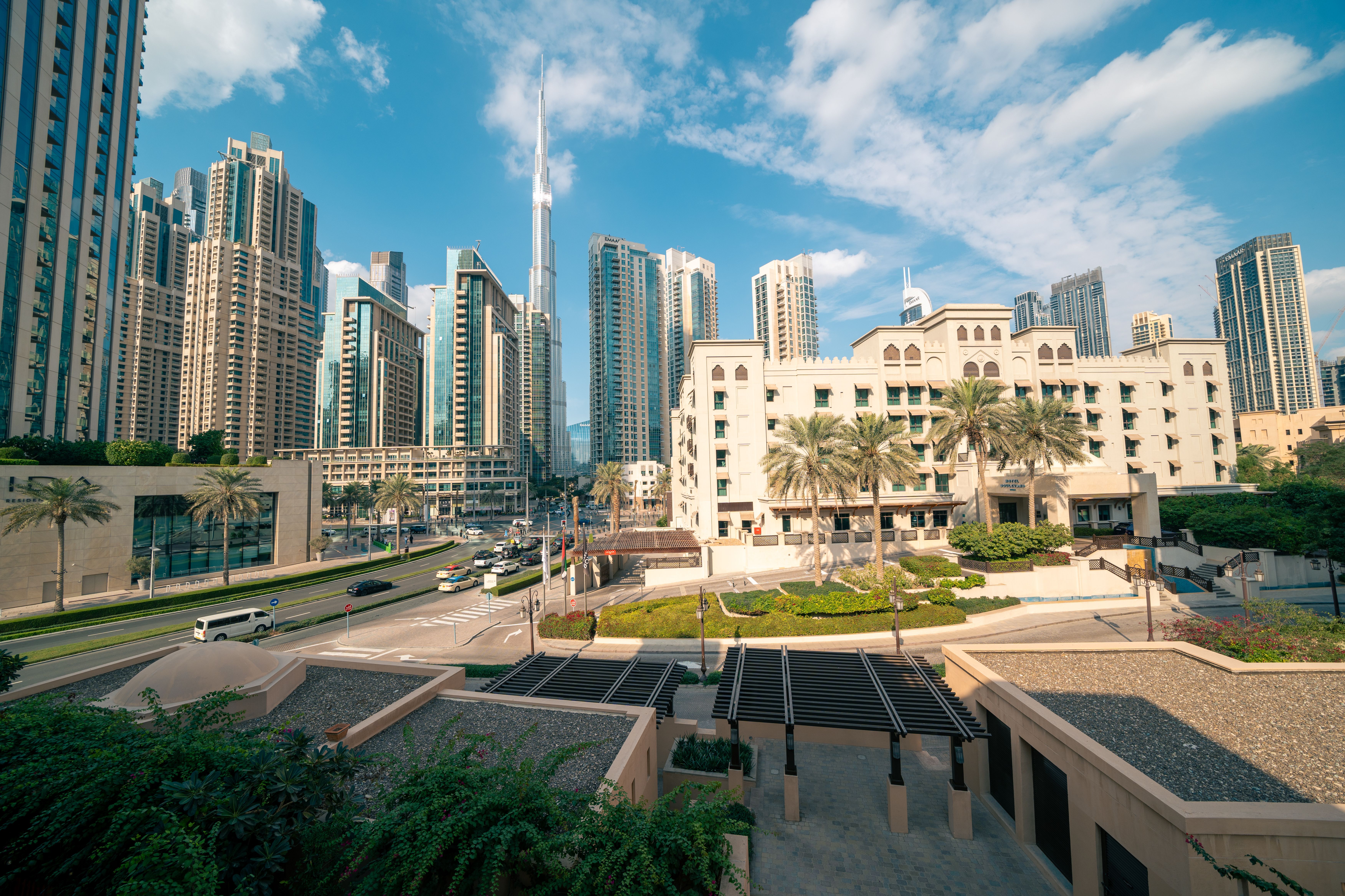 Panoramic view of Dubai's skyline featuring the Burj Khalifa on a sunny day.