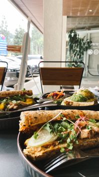 Delicious and fresh sandwiches with salad served outdoors. Perfect for a light, healthy meal.