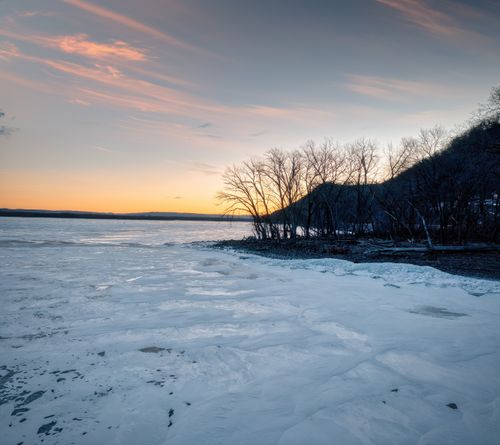 Free Serene winter sunset over a frozen lake at Camp Lacupolis, Minnesota. Stock Photo