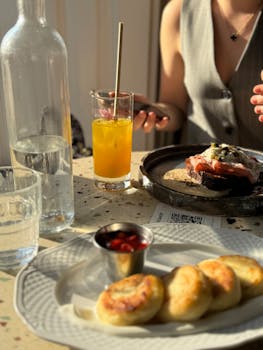 A cozy café brunch setting featuring a stylish dish and fresh orange juice, perfect for lifestyle stock photos.