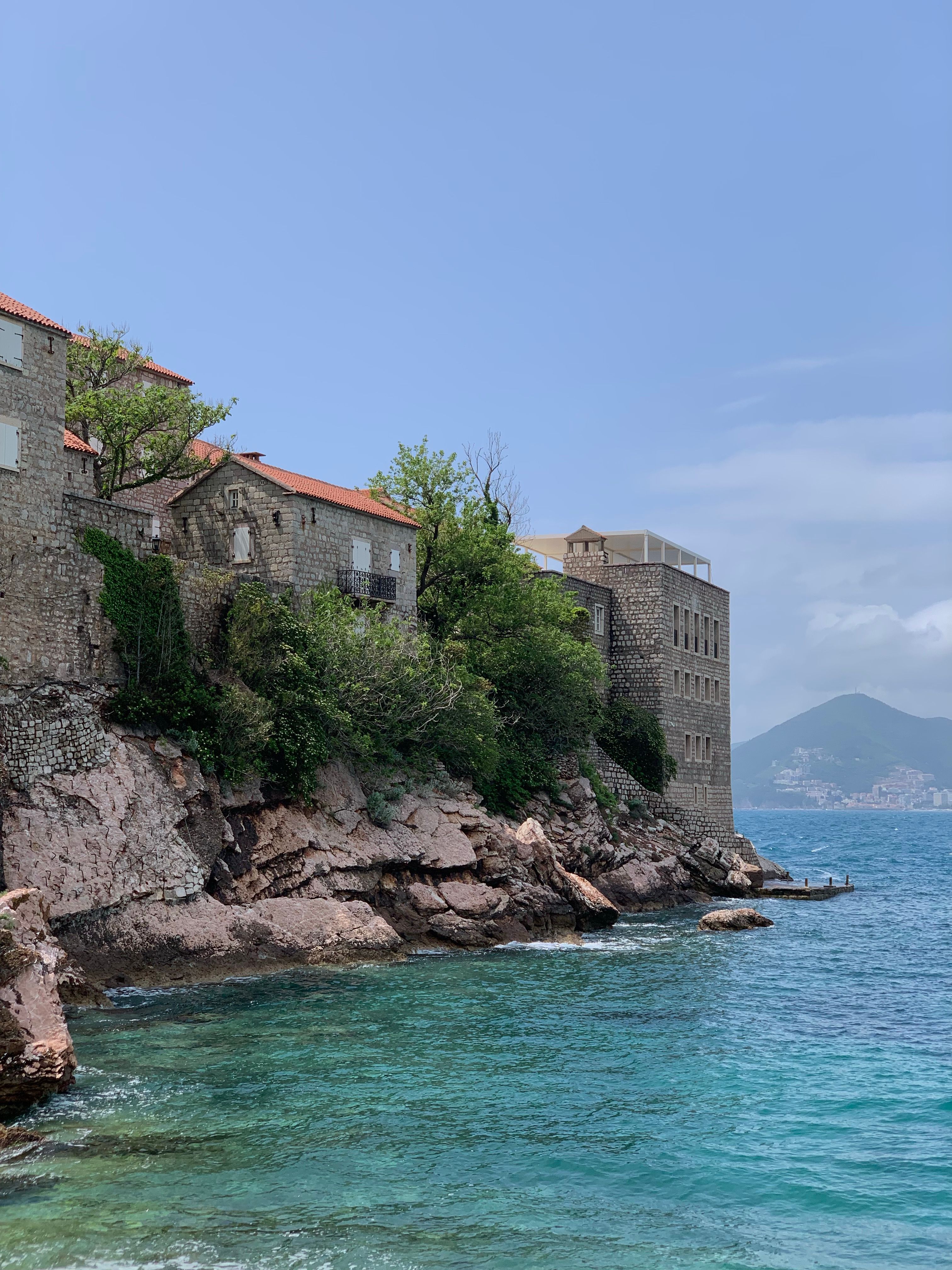 Coastal View of Historic Stone Buildings by the Sea · Free Stock Photo