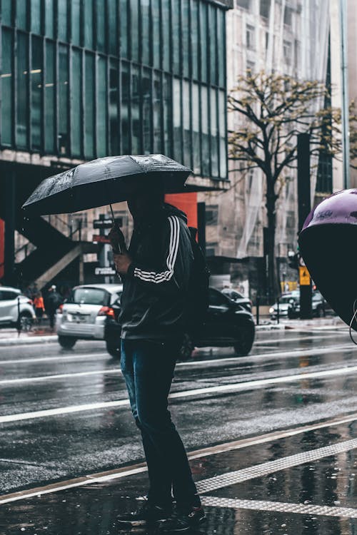 Man Holding Black Umbrella