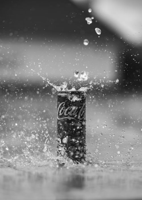 Free Captivating black and white photo of a Coca-Cola can with water splash effect, exuding refreshing vibes. Stock Photo