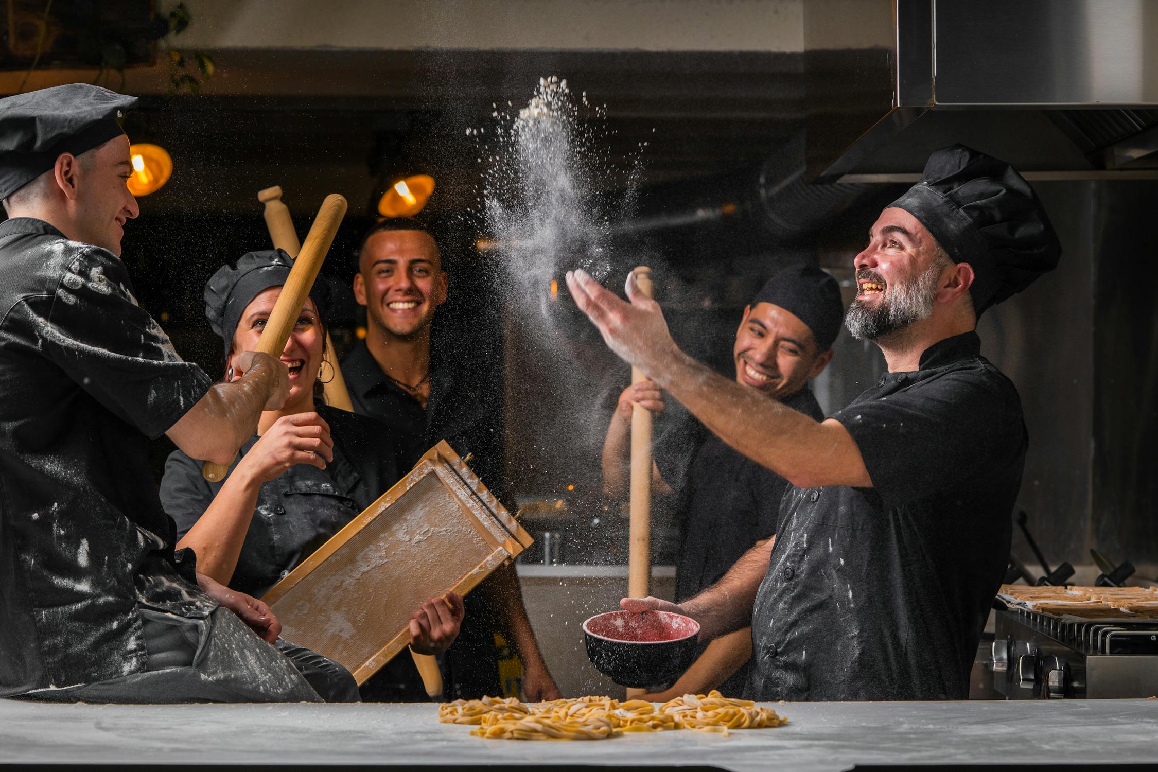 Chefs having fun making pasta in kitchen ยท Free Stock Photo