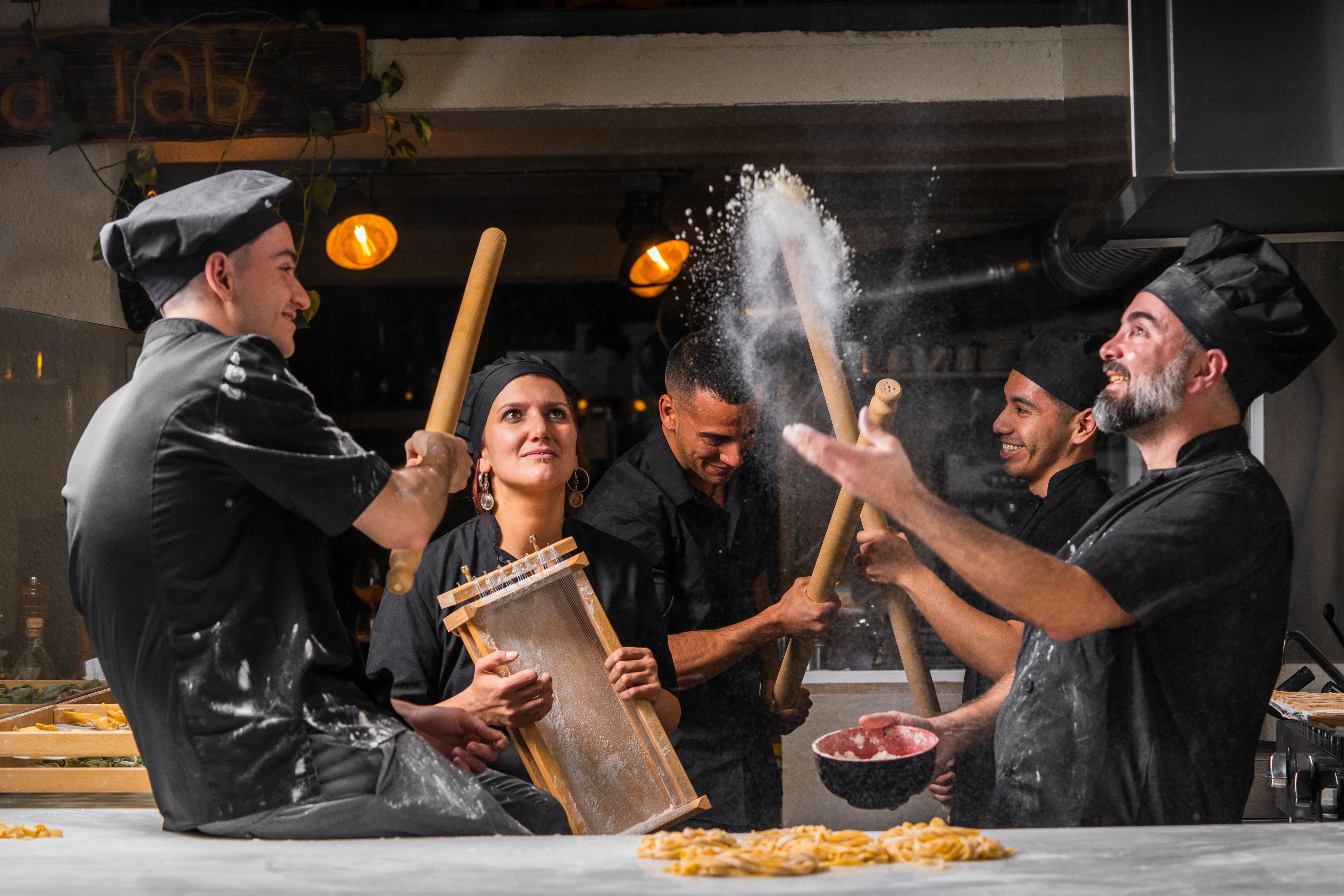 Chefs Enjoying Pasta Making in a Professional Kitchen · Free Stock Photo