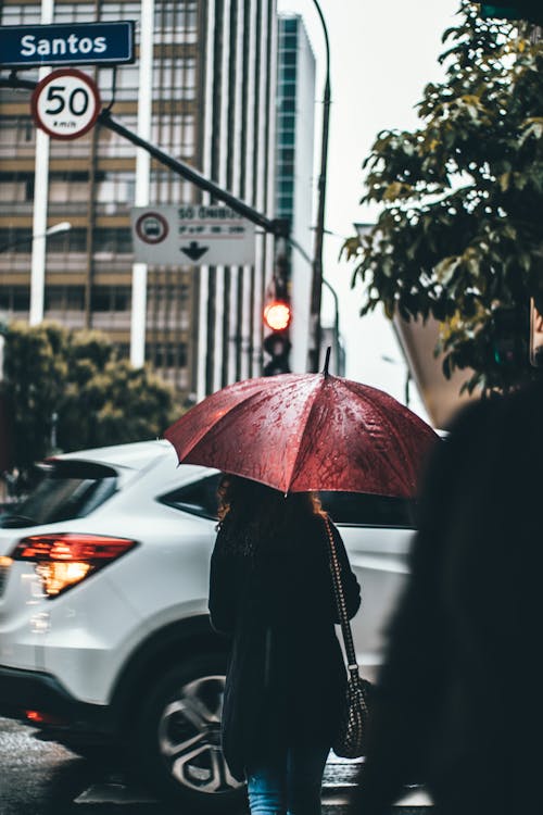 Woman Under Open Umbrella Near White Suv