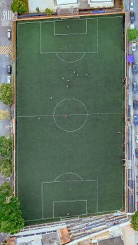 High-angle aerial shot of a soccer field during a casual game.