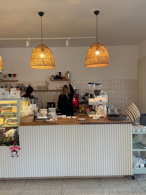 Free Charming cafe interior with baristas at work, showcasing modern decor and inviting atmosphere. Stock Photo