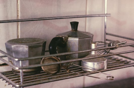 Vintage coffee makers and utensils on a kitchen rack create a nostalgic feel.