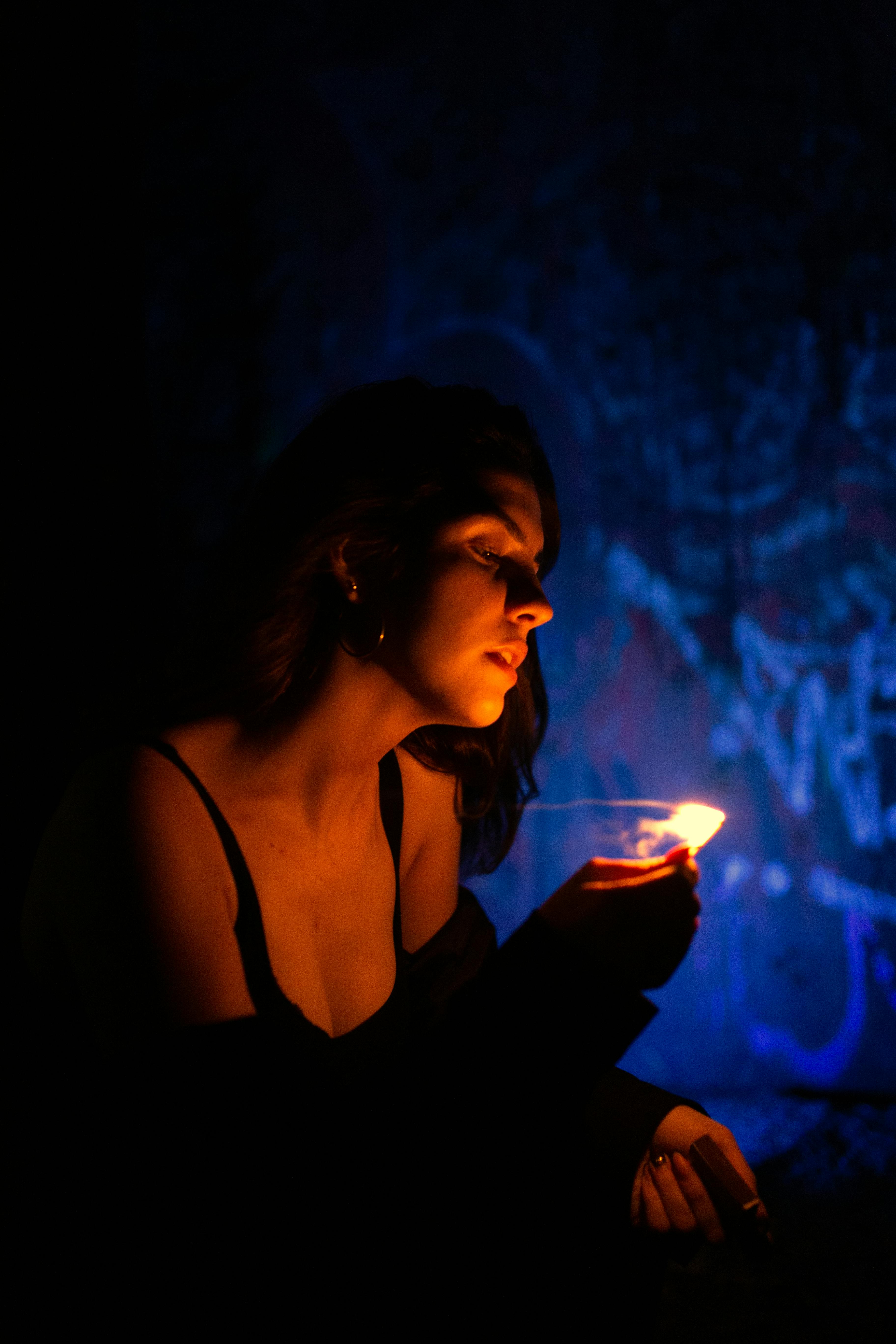 Moody Portrait of Woman Holding Lighter