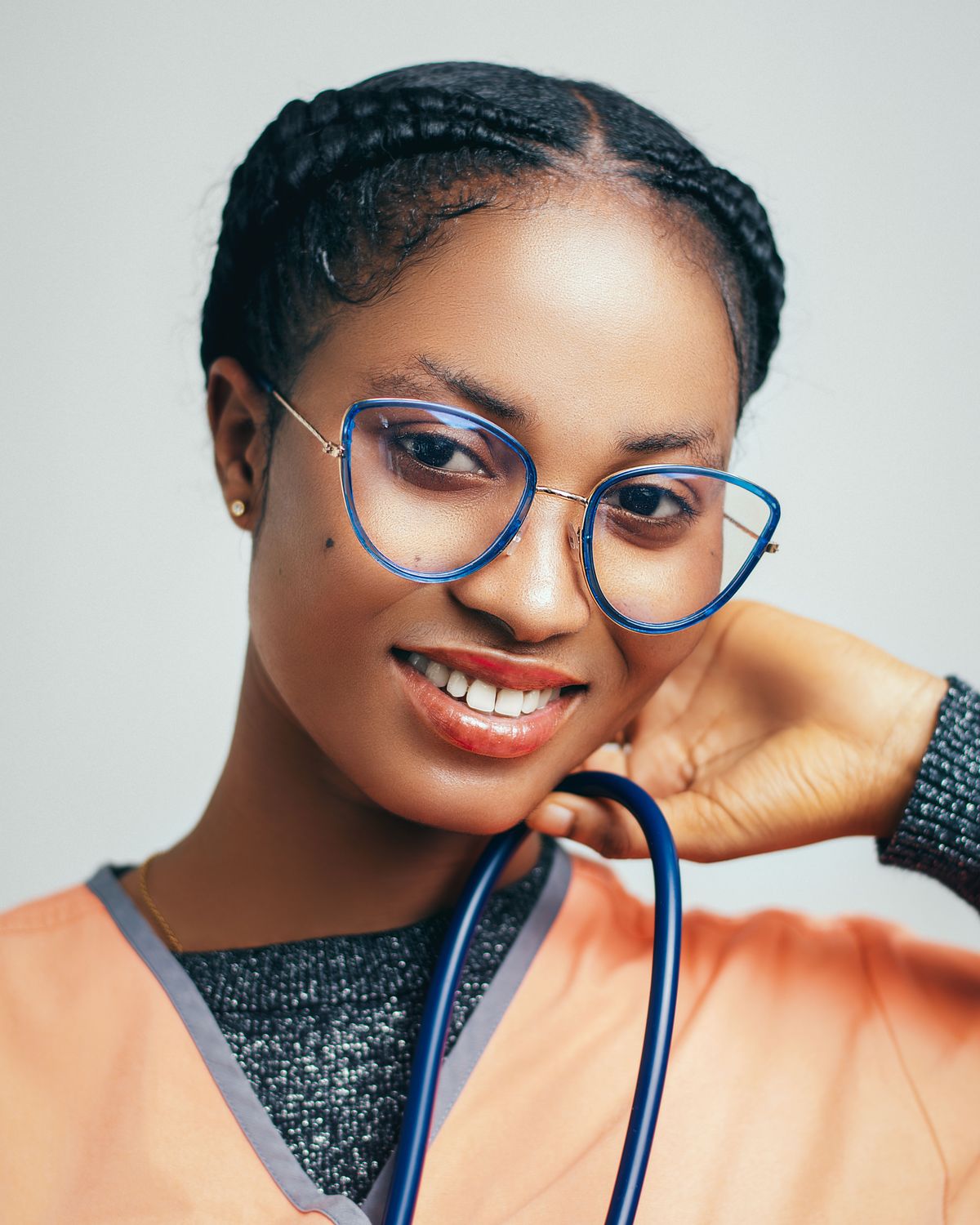 Smiling nurse with stethoscope and glasses