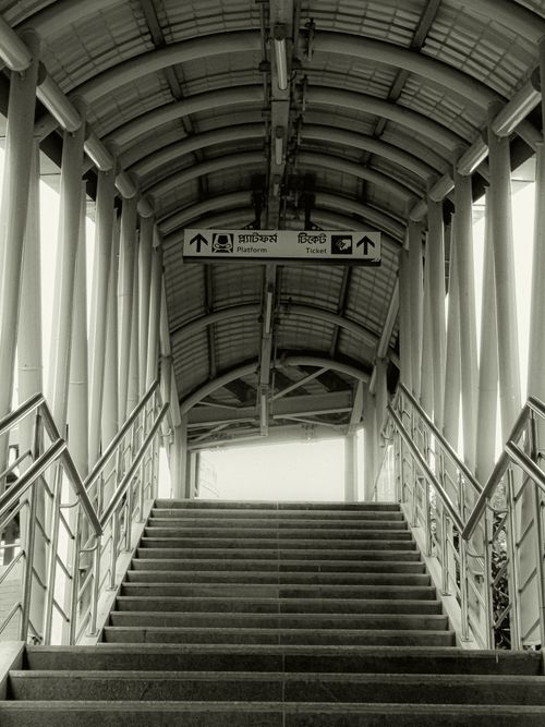 Free Elegant pedestrian bridge with signs in a metro station in Bangladesh. Stock Photo