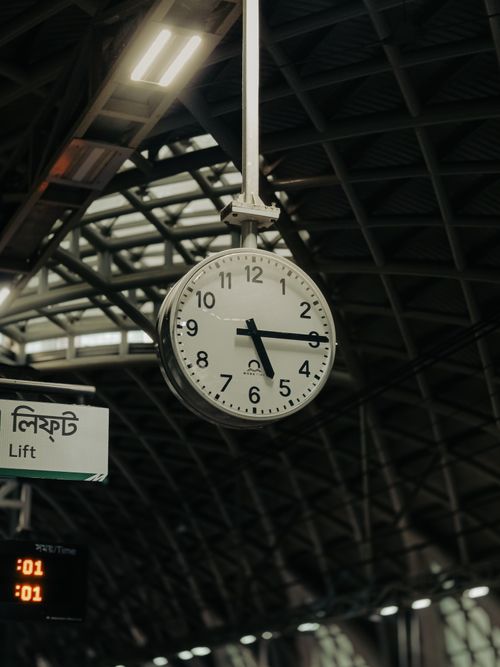 Free A vintage hanging clock in Dhaka metro station, showcasing unique architecture and city infrastructure. Stock Photo