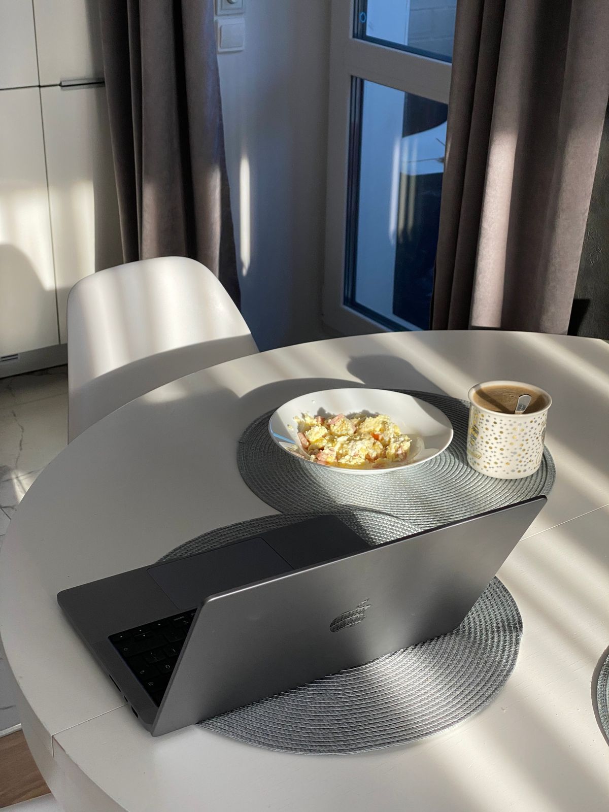 Laptop on a sunlit kitchen table representing the search for how to build a semi-passive income online in 2026