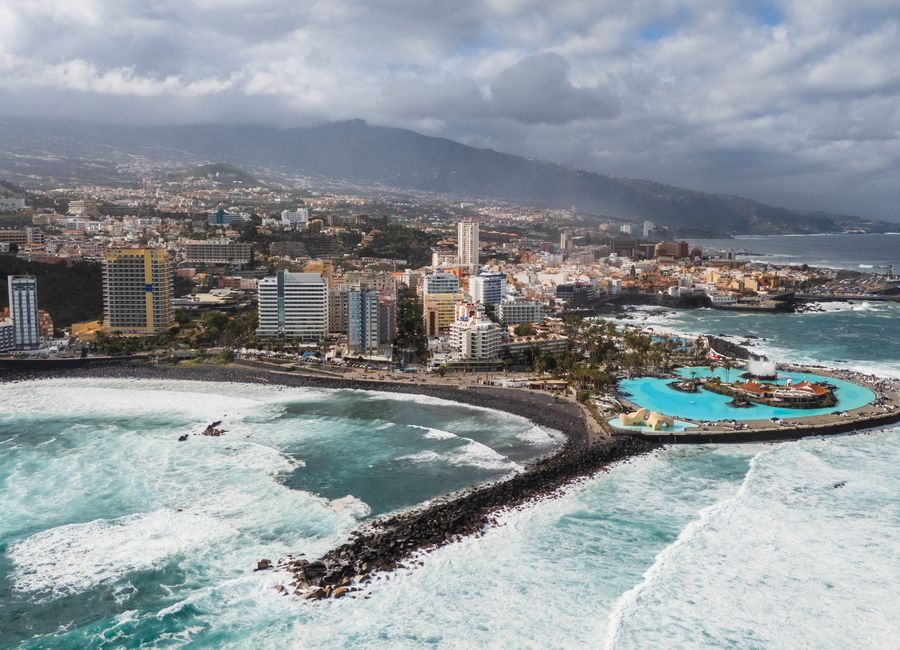 Captivating aerial shot of Puerto de la Cruz, Tenerife with ocean and cityscape.