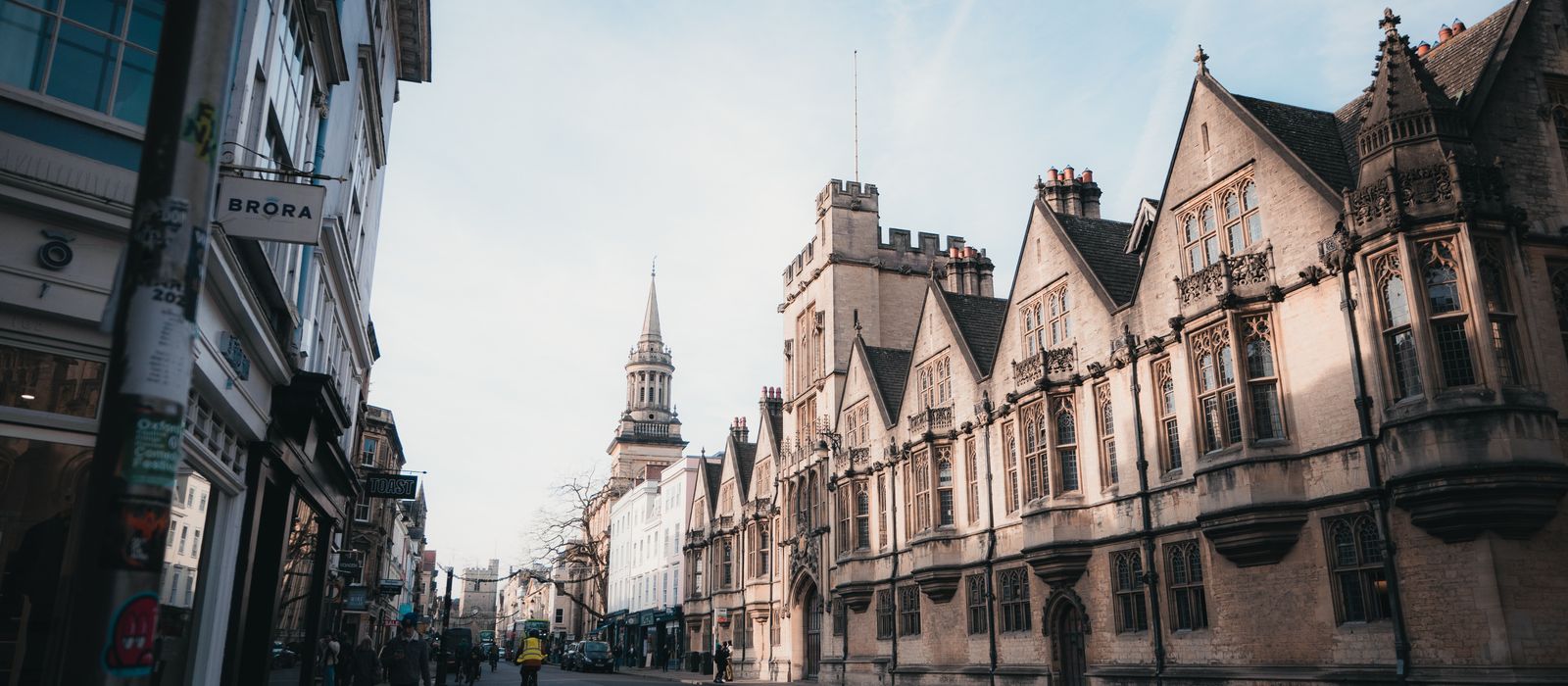 Captivating architectural view of a street in Oxford, England at sunrise, showcasing historic buildings.