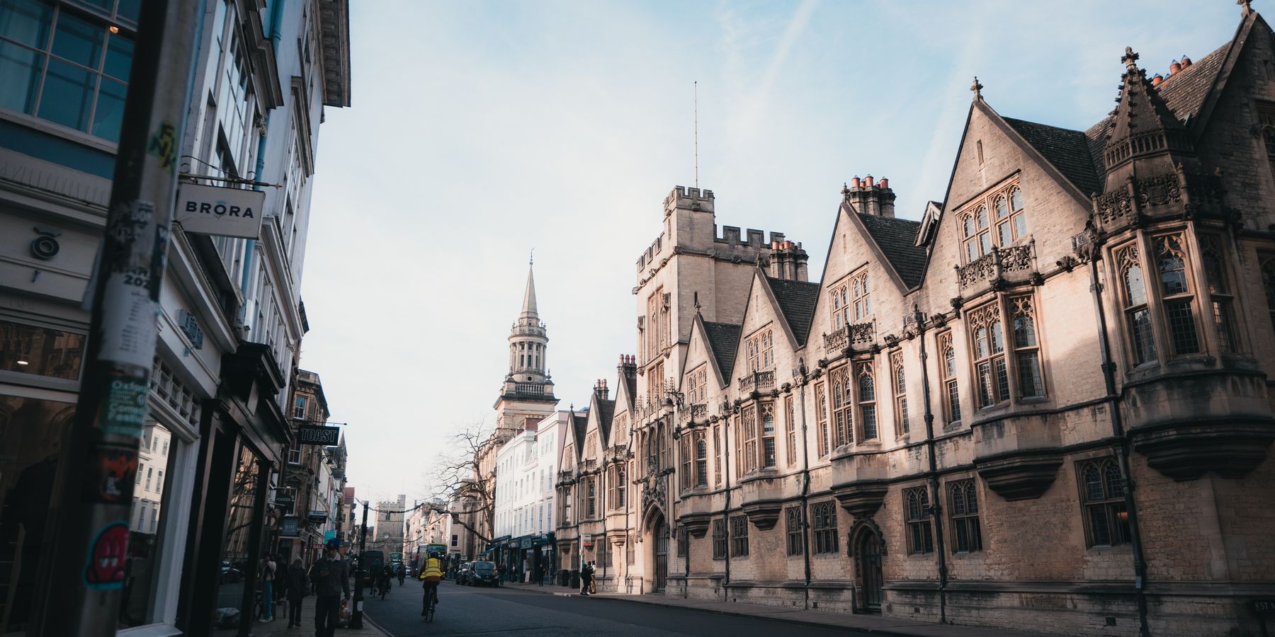 Captivating architectural view of a street in Oxford, England at sunrise, showcasing historic buildings.
