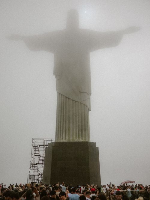 Free Fog surrounds the towering Christ the Redeemer statue in Rio, with a crowd below. Stock Photo