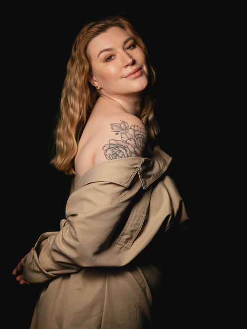 Free Elegant portrait of a woman showcasing a floral tattoo on her shoulder. Stock Photo