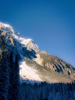 Breathtaking view of a snowy mountain range in Slovenia during winter.