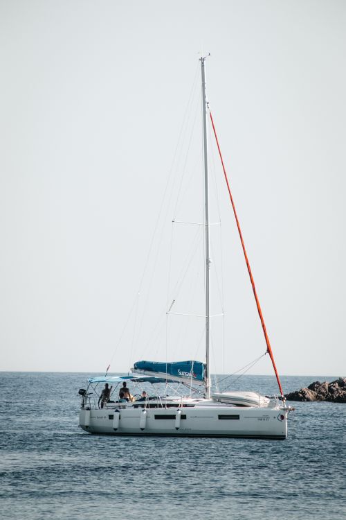 Free Serene scene of a sailboat on the calm Adriatic Sea off Lopud, Croatia. Stock Photo