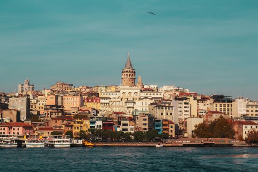 Beautiful view of Galata Tower and vibrant Istanbul skyline by the Bosphorus.