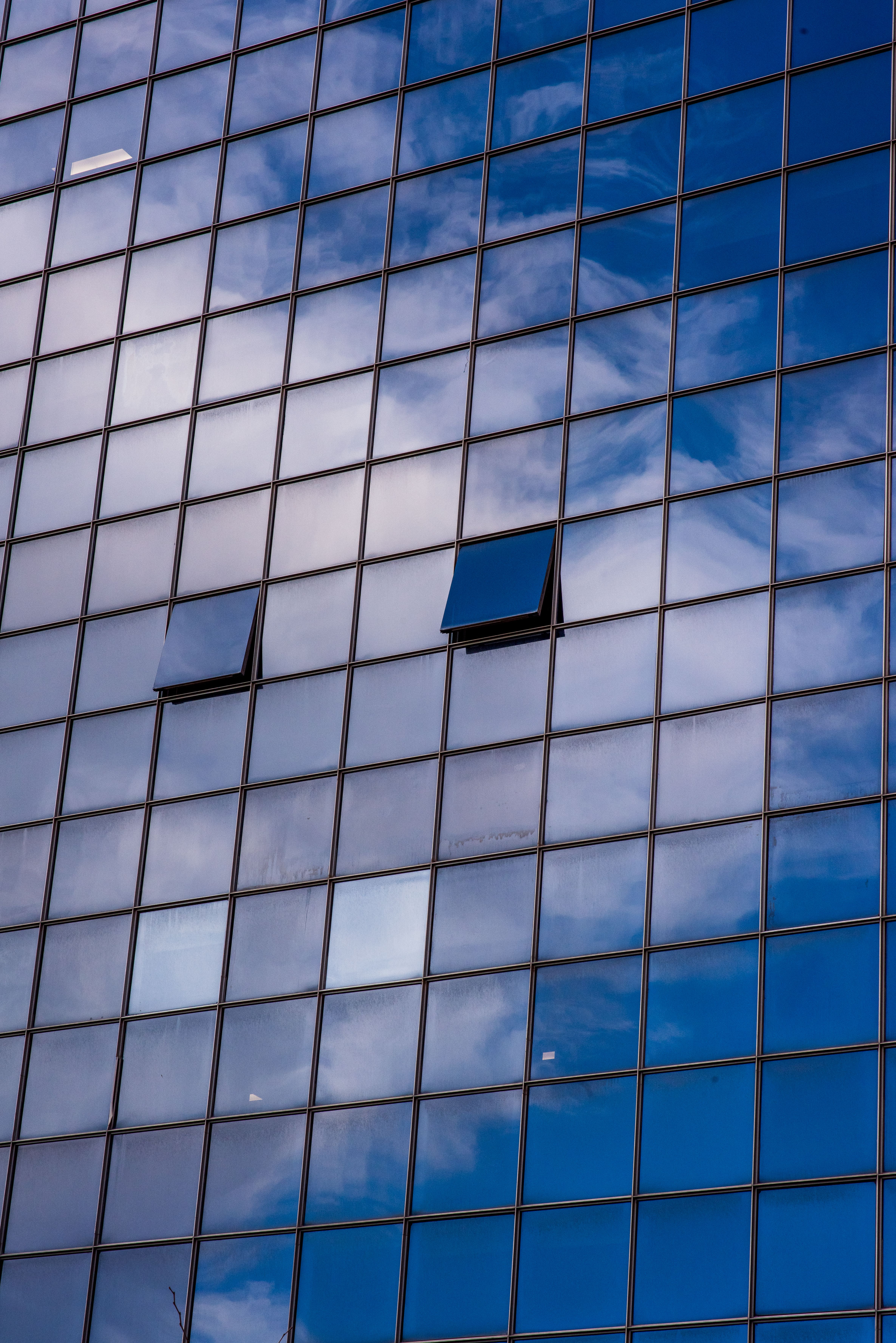 Modern Glass Building Reflecting Blue Sky · Free Stock Photo