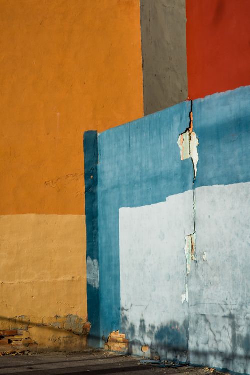 Free Vibrant textured wall with cracks and peeling paint in urban setting. Stock Photo