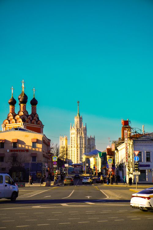 Free A vibrant cityscape featuring historic architecture under a clear blue sky. Stock Photo