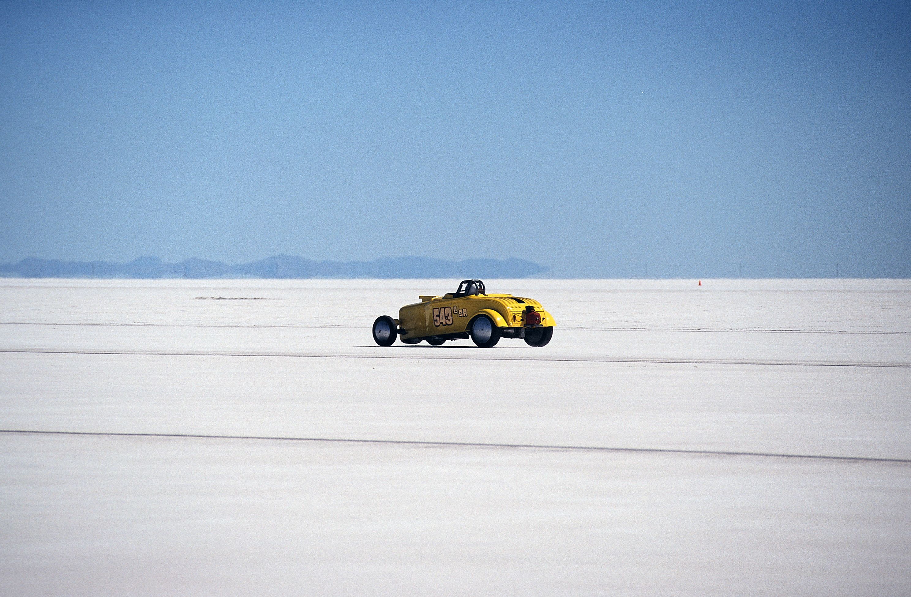 Yellow Hot Rod Racing Across Salt Flats in Utah · Free Stock Photo