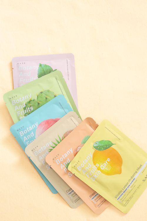 Free Colorful botanical sheet masks for skincare on pastel background. Stock Photo