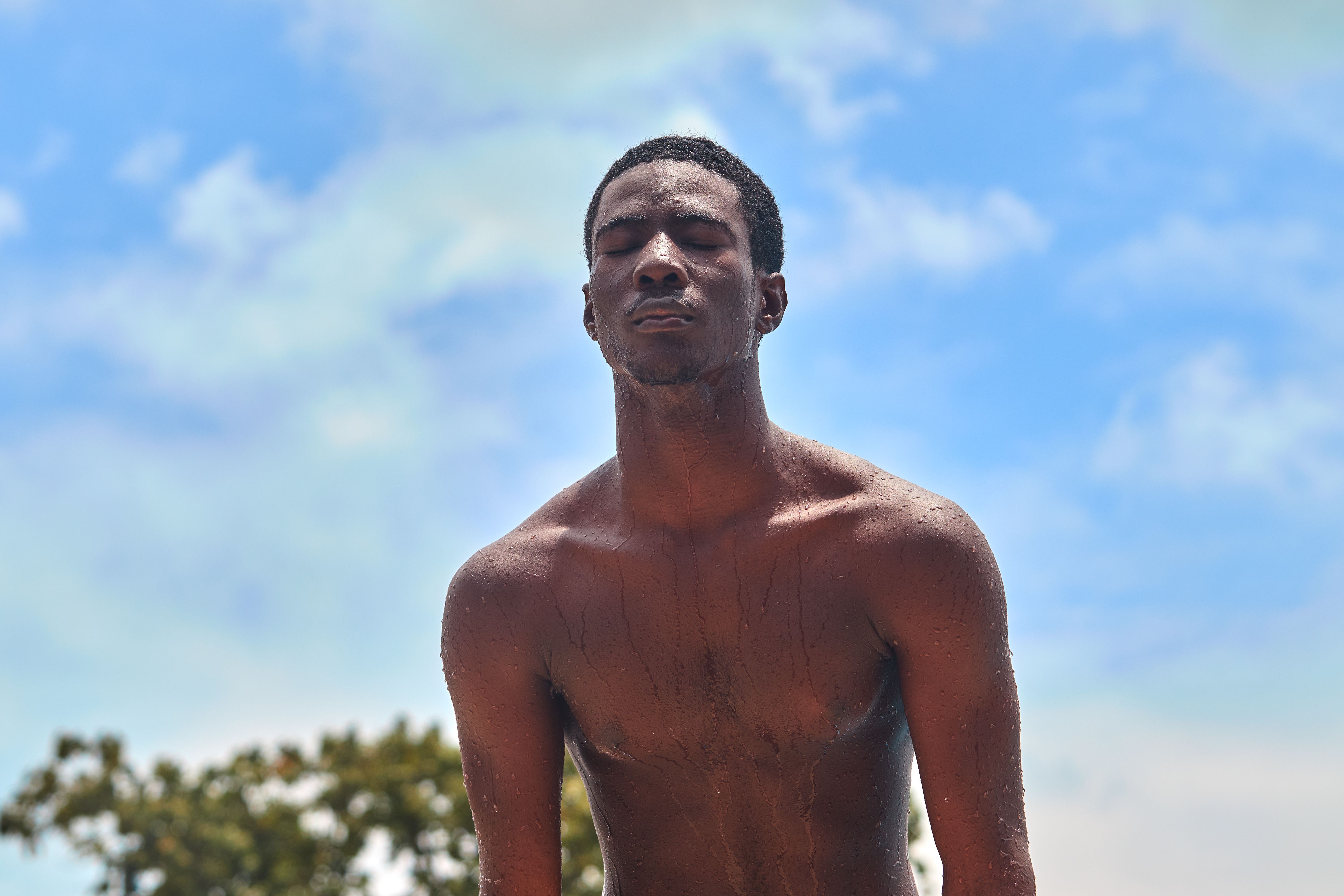 Young man enjoying a refreshing summer day · Free Stock Photo