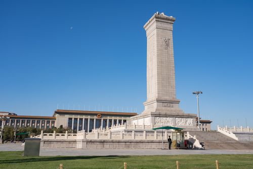 Free Monument to the People's Heroes in Tiananmen Square, Beijing, China, under a clear blue sky. Stock Photo