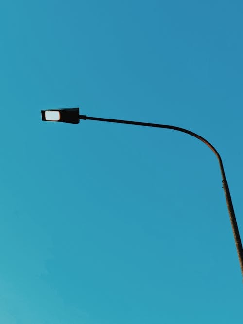 Free Low-angle Photo of a Lit Streetlight Under a Clear Sky Stock Photo