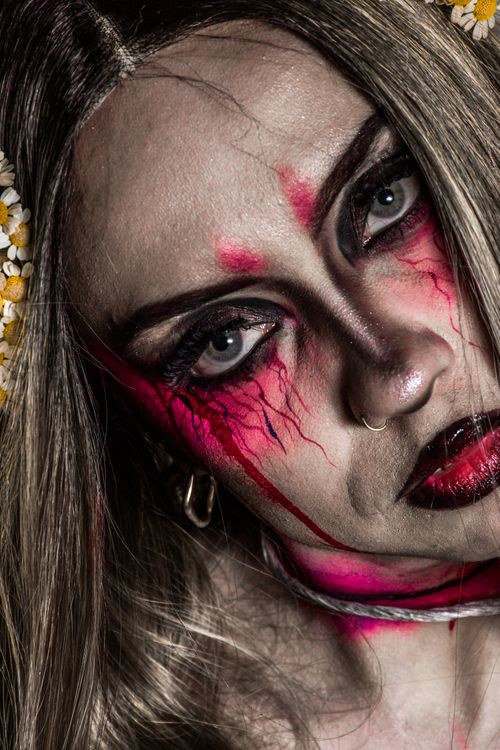 Free Intense close-up portrait featuring artistic, haunting Halloween makeup. Stock Photo