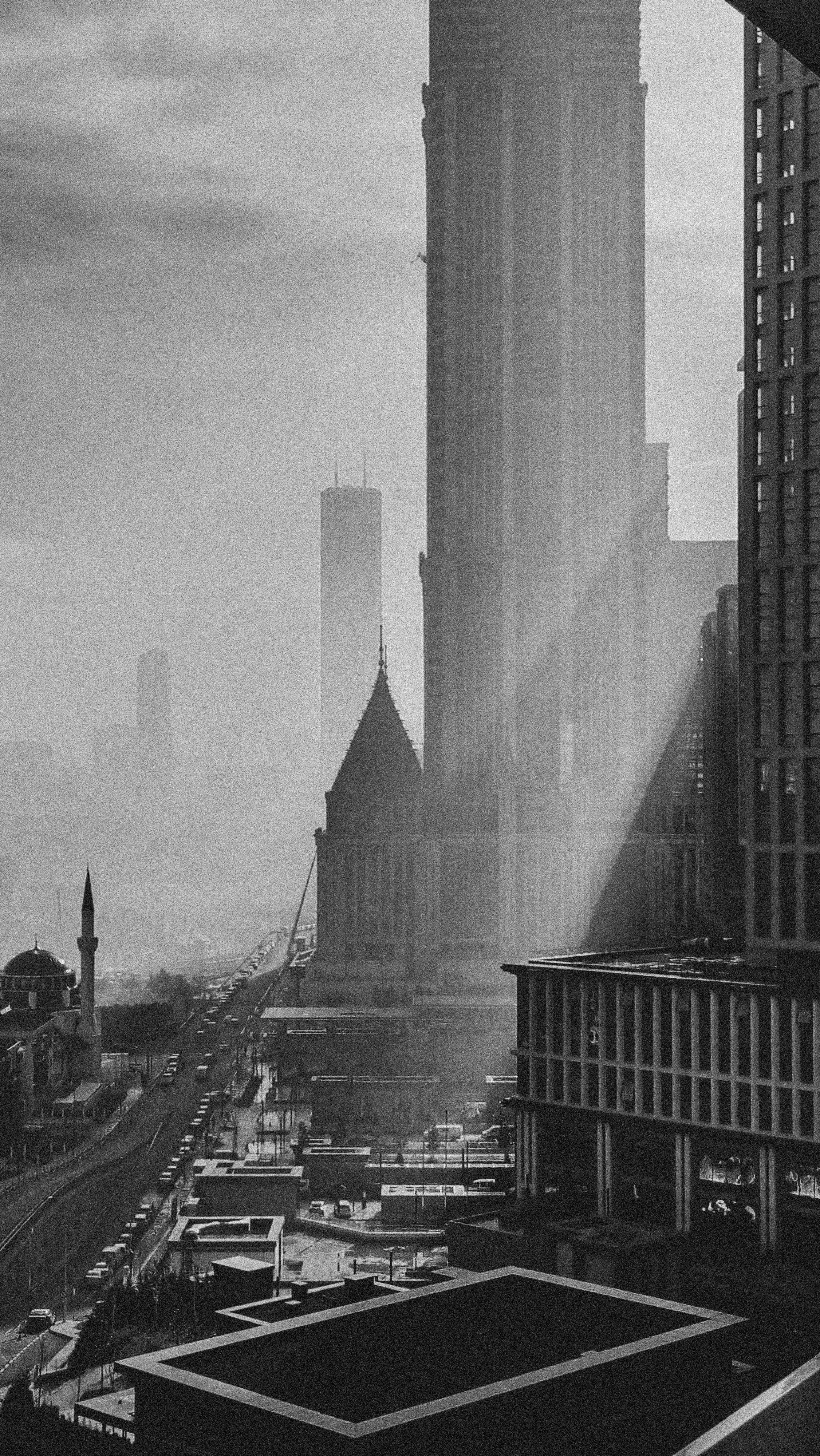 Dramatic black and white capture of Istanbul's modern skyline with striking sunlight rays.