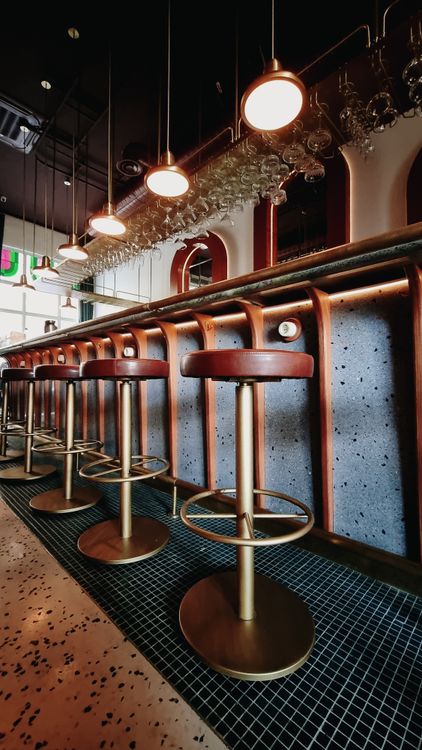 Modern Bar Interior with Leather Stools · Free Stock Photo