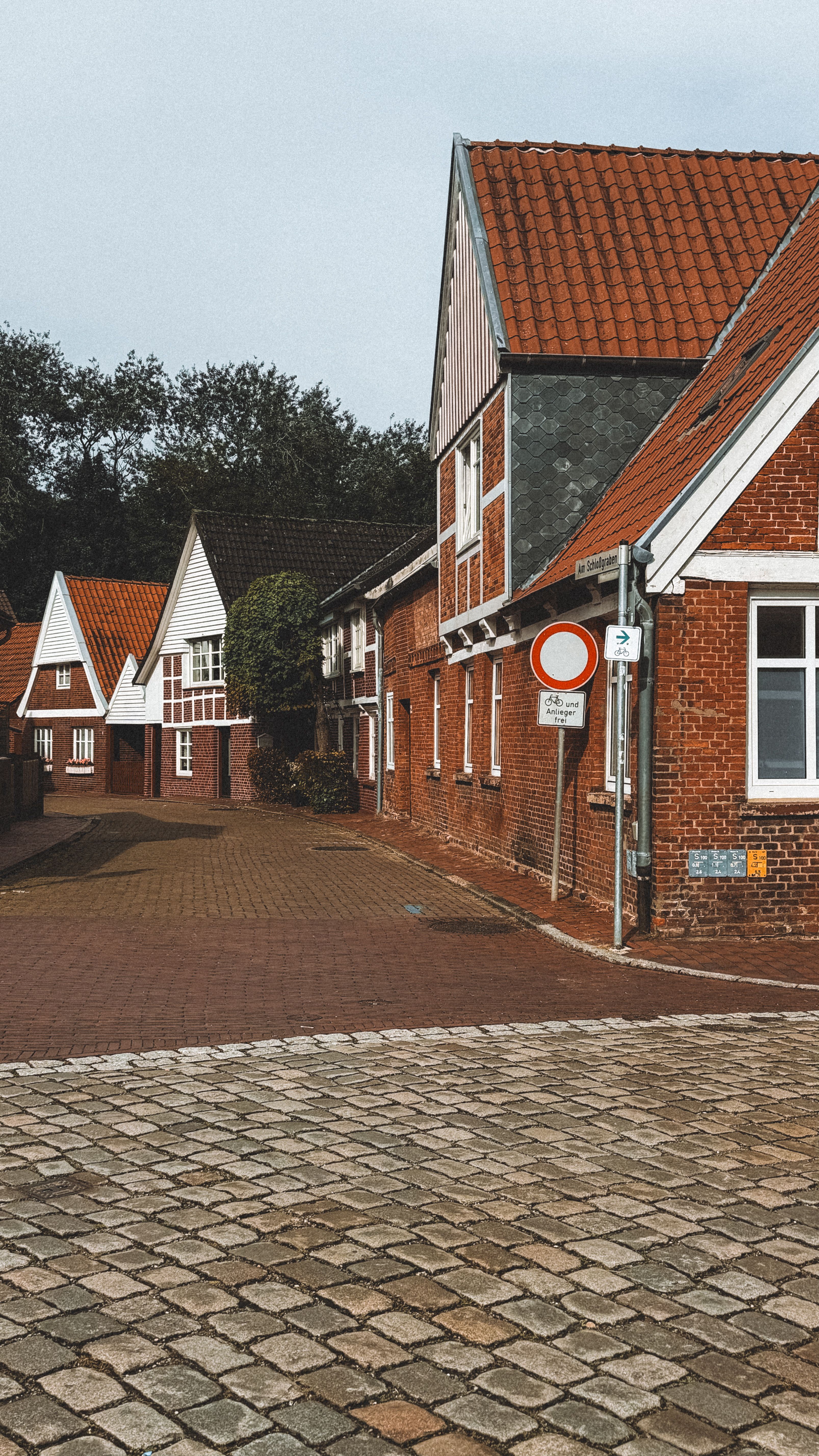 Picturesque red-brick houses in Ottendorf-Okrilla, Germany on a quiet street.
