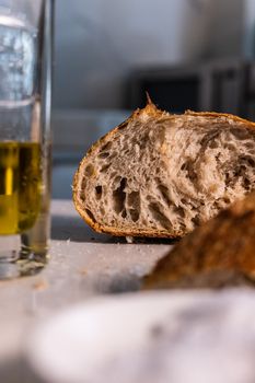 Artistic shot of rustic bread and olive oil highlighting texture and freshness.