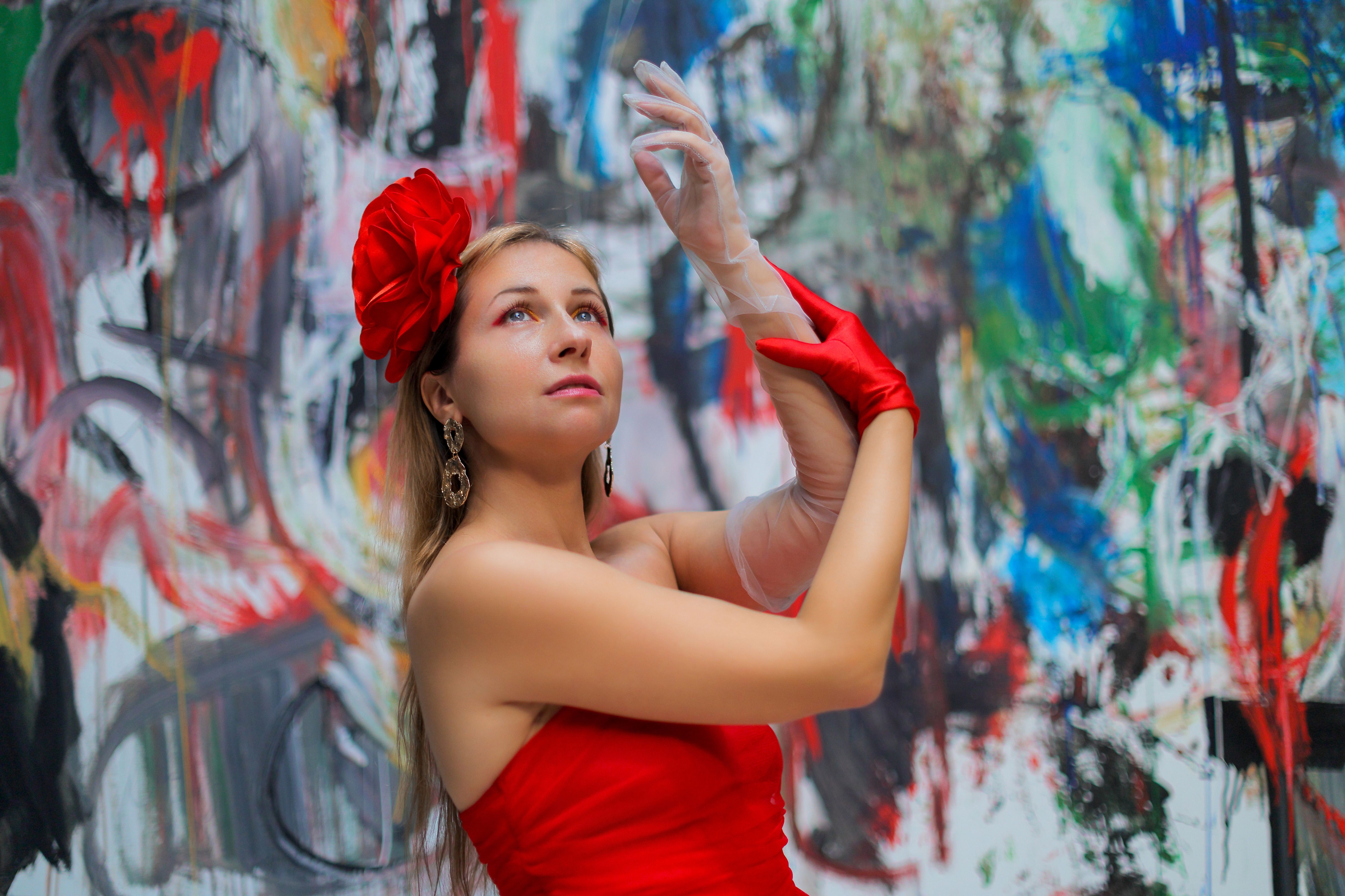 Elegant Woman in Red Dress Posing with Art Background · Free Stock Photo