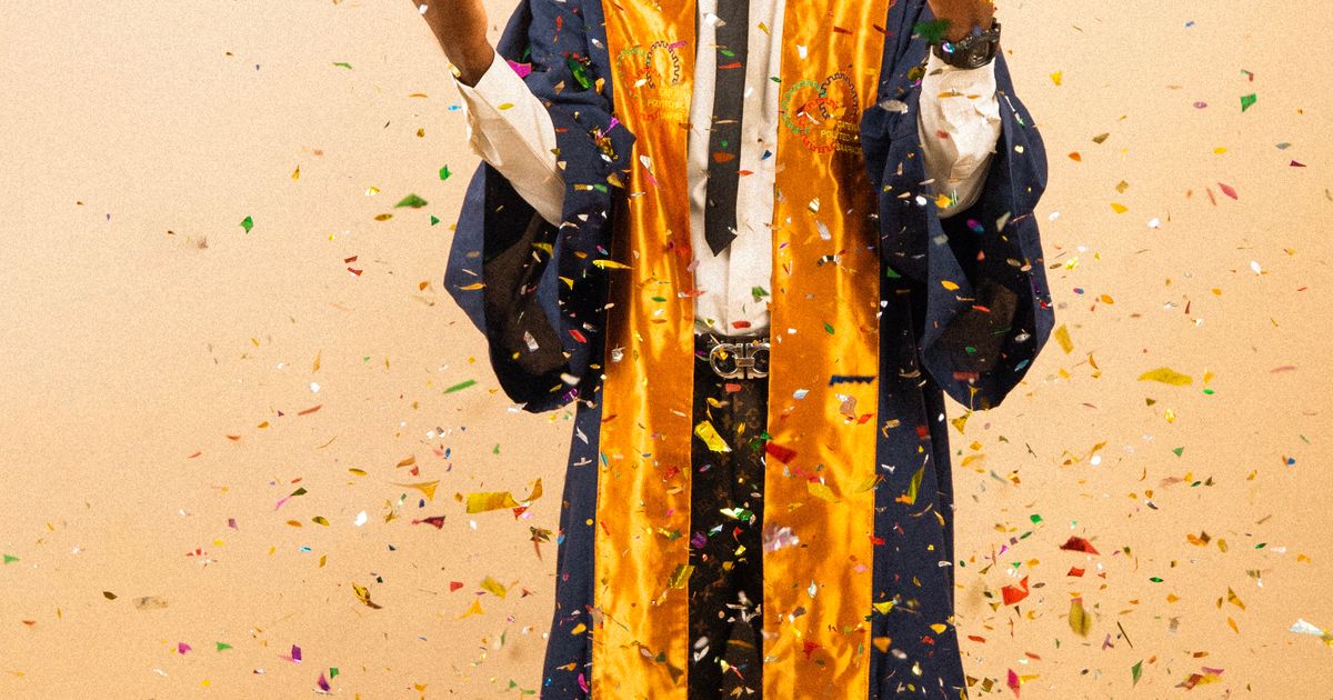 Graduate celebrating with confetti in cap and gown