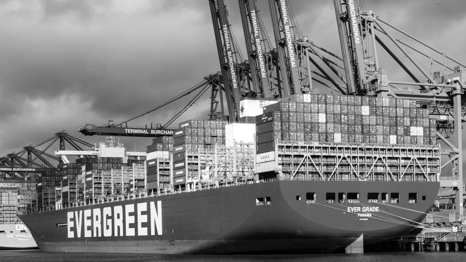 Large container ship docked at Terminal Burchardkai in Hamburg, showcasing global logistics.