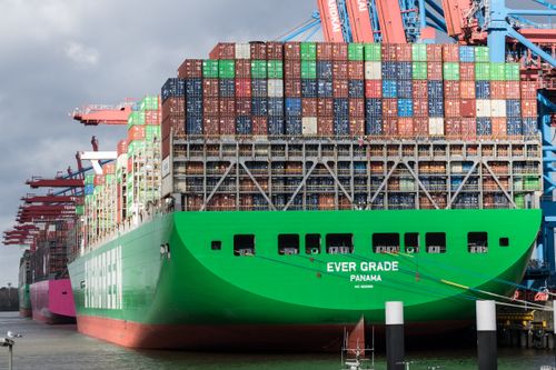 Free Huge container ship docked at Hamburg terminal in bright daylight. Stock Photo