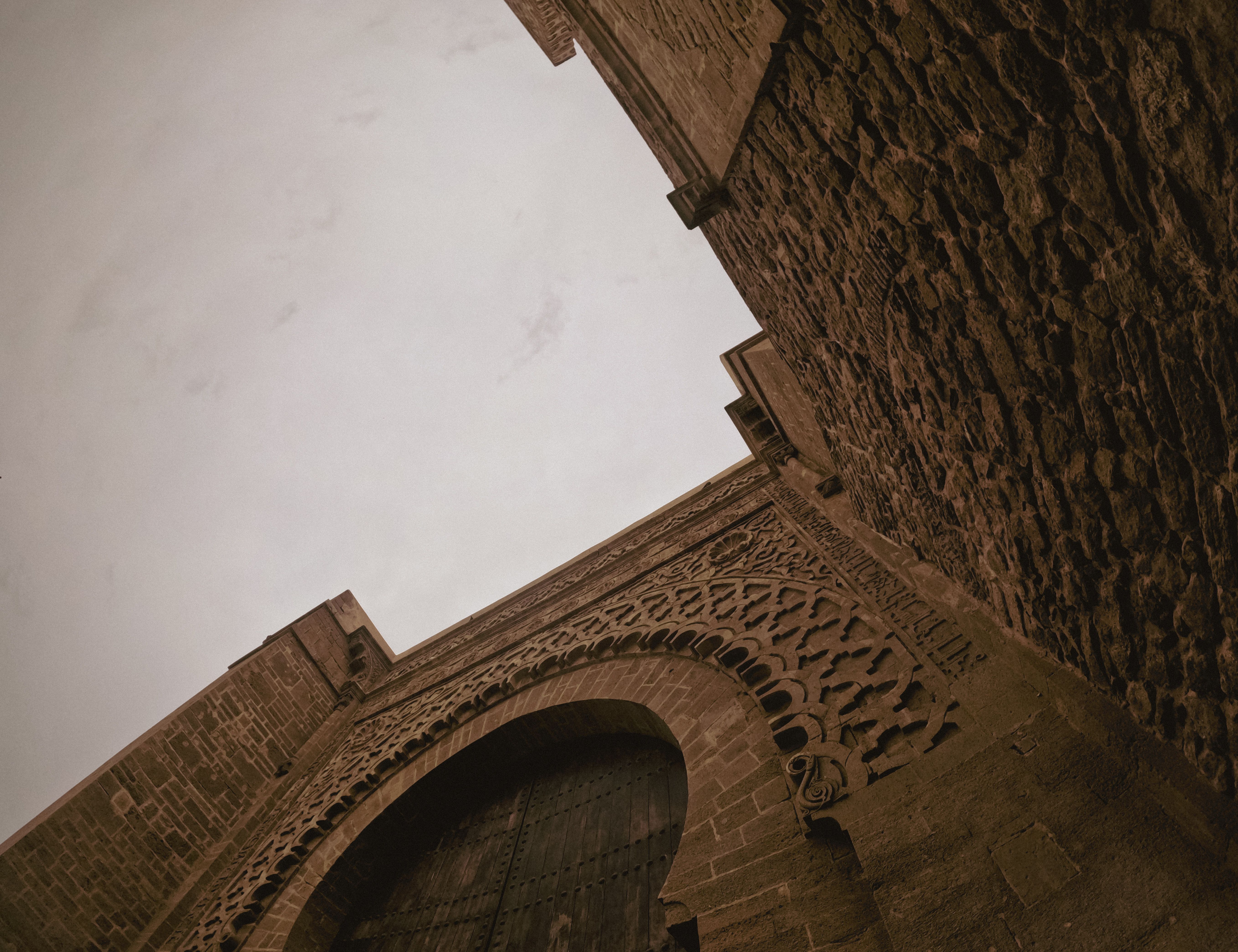 Ancient Stone Gate with Intricate Arch Design · Free Stock Photo