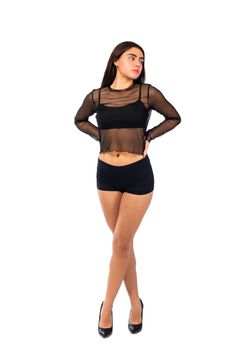 Striking portrait of a confident woman in a sheer black top and shorts, exuding elegance and empowerment.