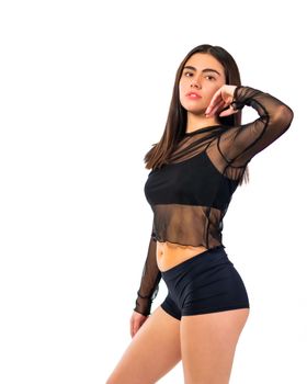 Artistic portrait of a confident woman striking a pose in stylish attire, capturing elegance and empowerment.
