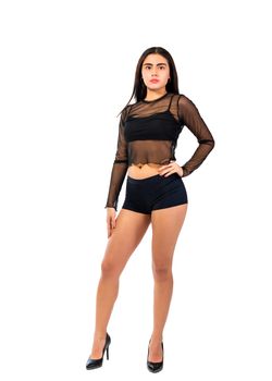 Portrait of a confident young woman in a sheer black outfit, exuding elegance and empowerment.